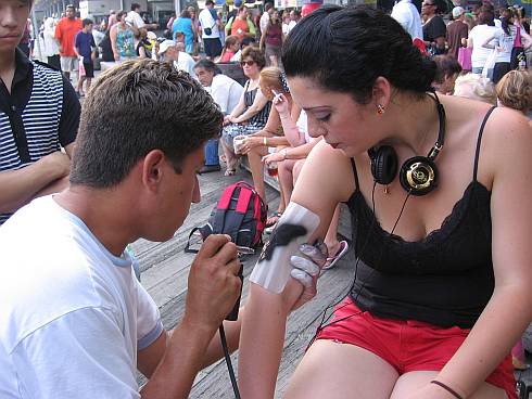 A girl getting an air-brush tattoo